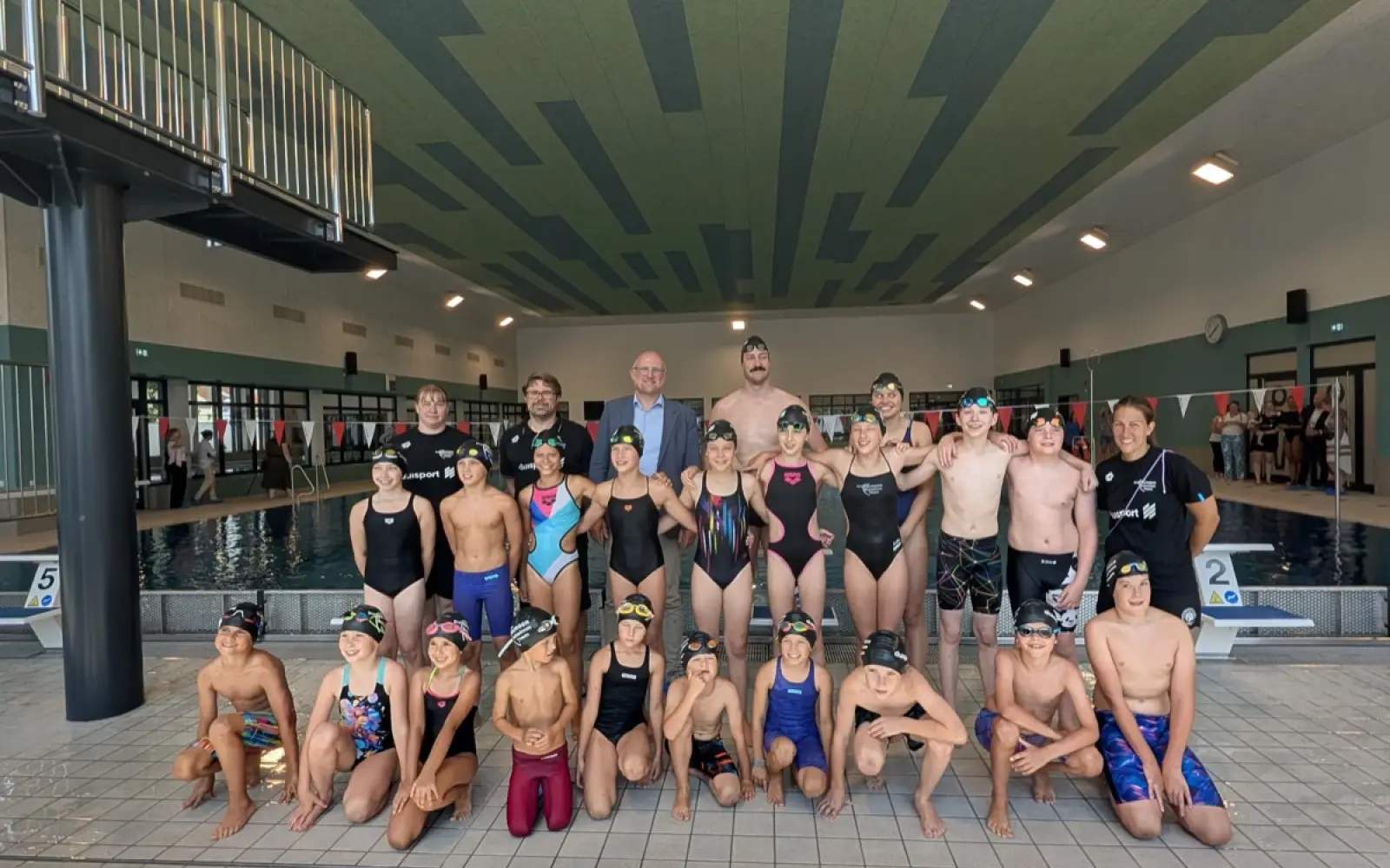 Junge Schwimmerinnen und Schwimmer weihten das neue Sportbecken gleich am Eröffnungstag ein und stellten sich mit Oberbürgermeister Sören Link zum Gruppenbild auf. Foto: ah