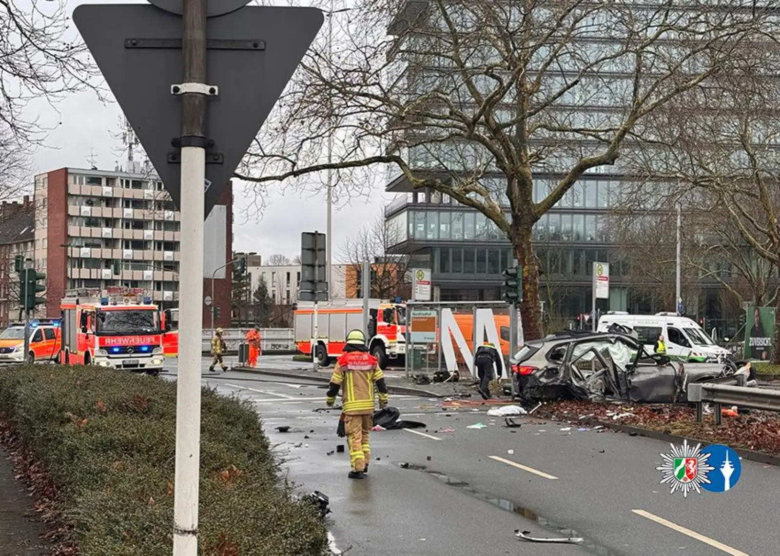 Einsatzkräfte der Feuerwehr und Polizei sichern die Unfallstelle am Verteiler Nordfriedhof. Der stark beschädigte BMW kam an der Bushaltestelle zum Stehen. Foto: Polizei Düsseldorf