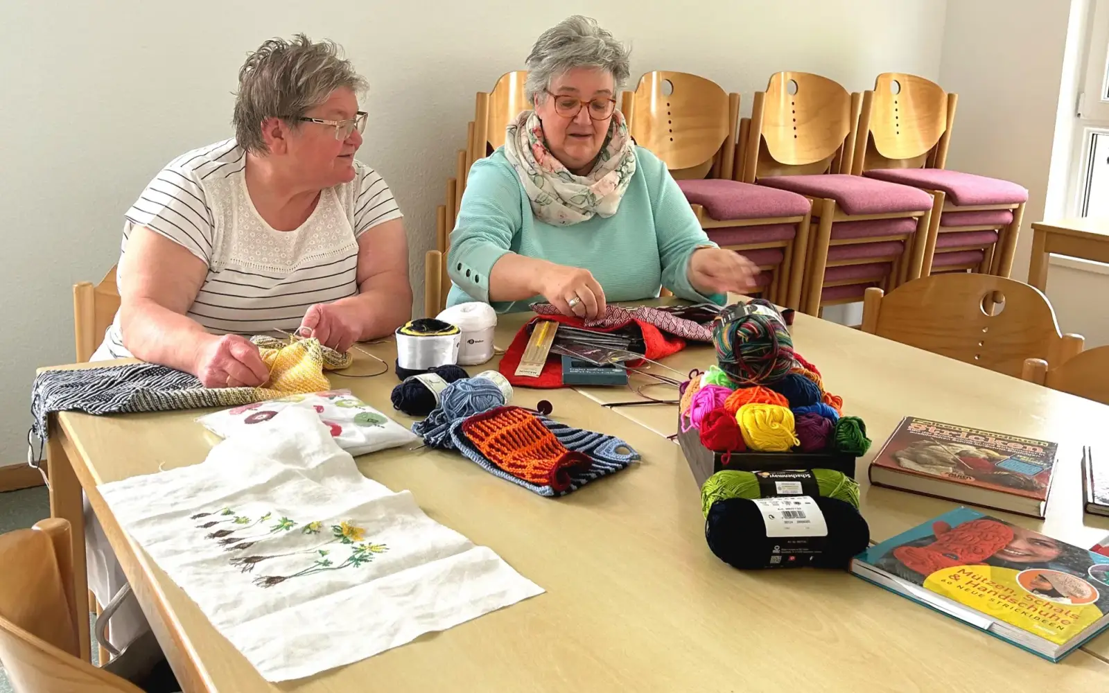 Regina und Gisela vom Kreativ-Team geben gute Tipps zum Stricken und Häkeln. Foto: Evangelische Rheingemeinde Duisburg.