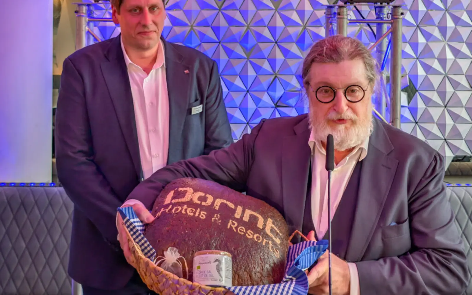 Hoteldirektor Christian Schulte (links) erhält von Dirk Iserlohe Brot und Salz als Willkommensgeschenk. Foto: ah
