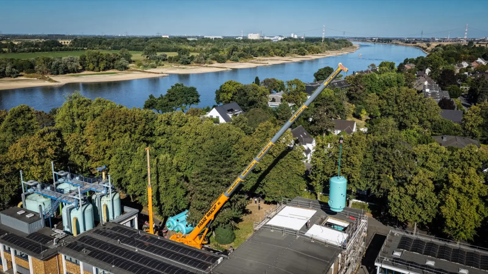 Durch das geöffnete Dach der Filterhalle hebt ein Kran einen der neuen Großfilter in das Wasserwerk Düsseldorf-Wittlaer ein. Foto: Stadtwerke Duisburg