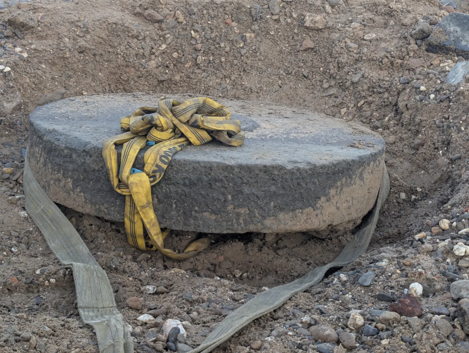 Mit Hebegurten gesichert liegt der Mühlenstein frei im Uferschlamm, bei normalem Pegel ist die Fundstelle überspült. Foto: ah